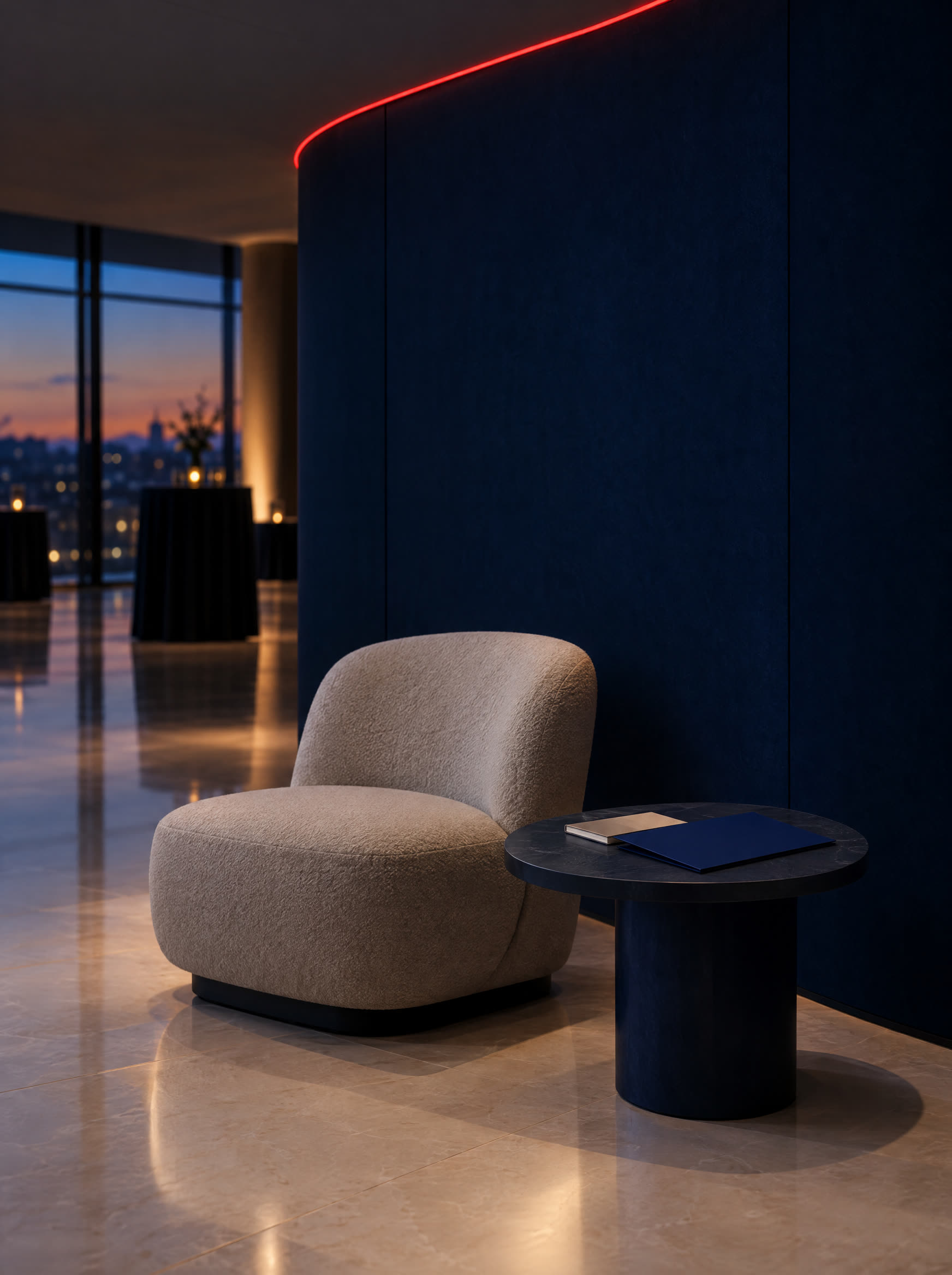 A quiet corner of a venue at dusk: one chair, a low table and a folder.